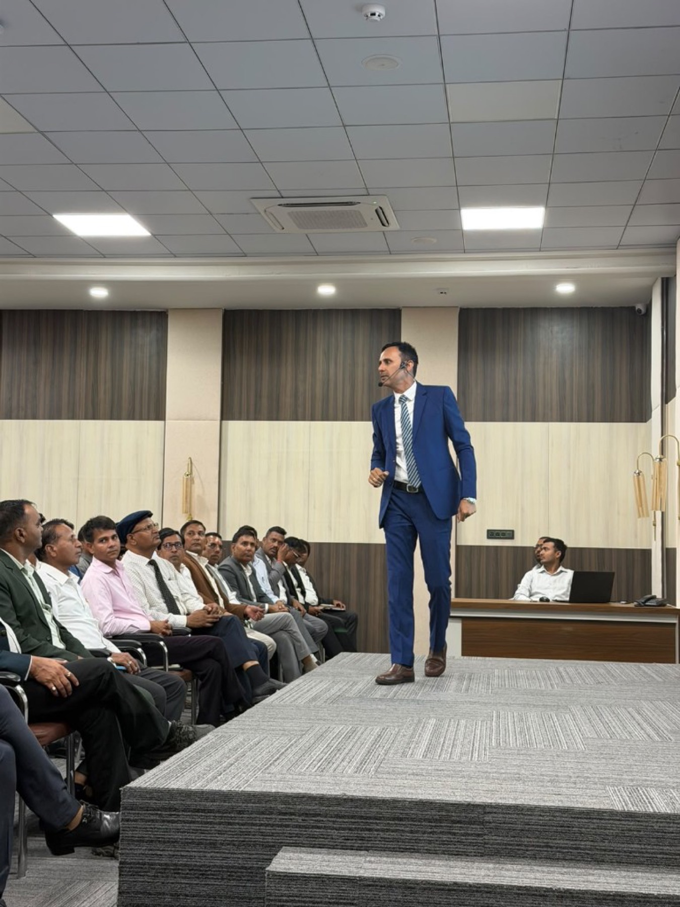 Bhupendra Singh Shekhawat walking a training room while teaching